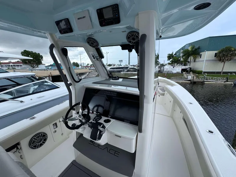 Slide: The Image of Interior view of 2024 Solace 32 CS boat with modern helm and controls. - 14