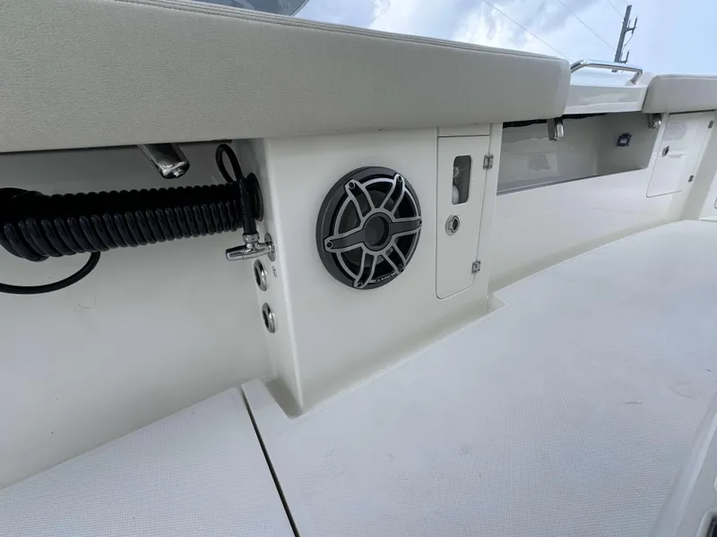 Slide: The Image of 2024 Solace 32 CS boat interior with speaker and storage compartments. - 18