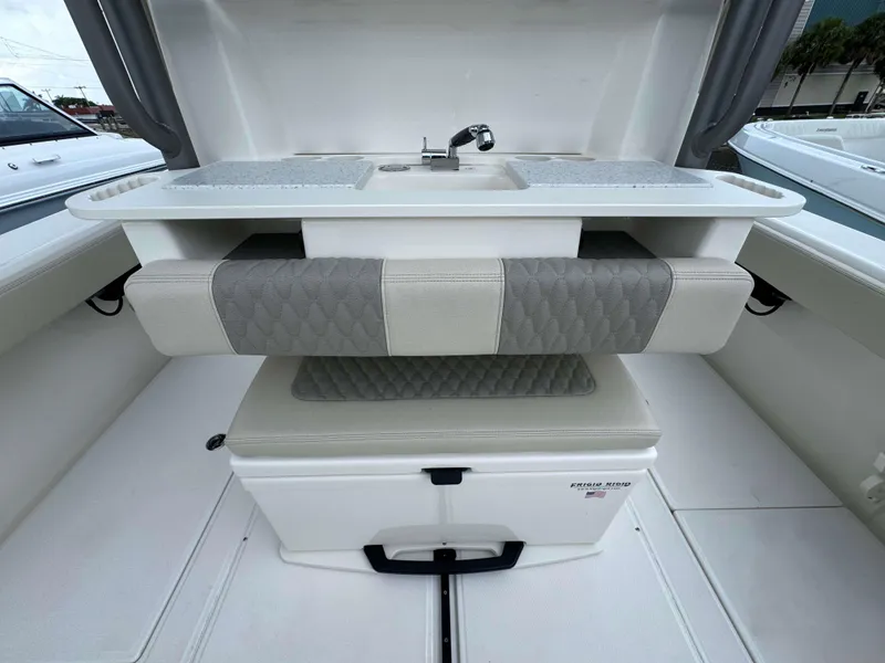 Slide: The Image of 2024 Solace 32 CS boat interior with cushioned seating and sink. - 22
