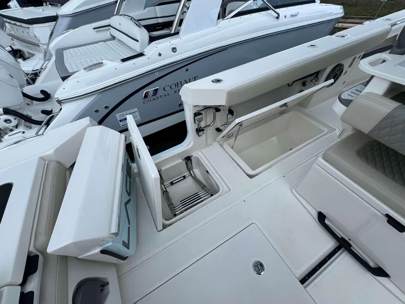 Slide: The Image of 2024 Solace 32 CS boat interior with open storage compartments and seating. - 23