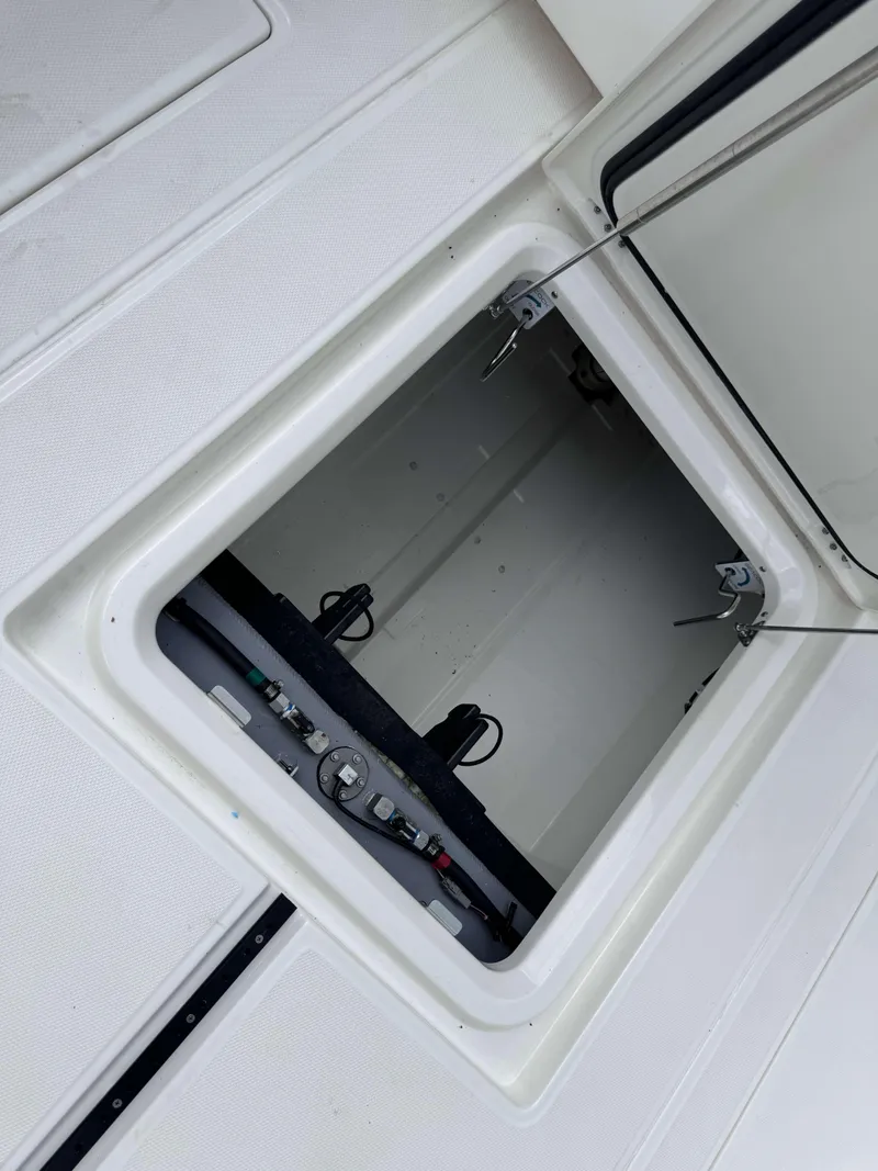 Slide: The Image of Open storage compartment on a 2024 Solace 32 CS boat. - 24