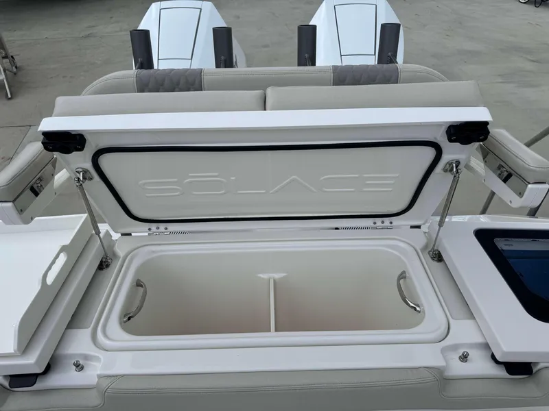 Slide: The Image of 2024 Solace 32 CS boat with open storage compartment. - 25