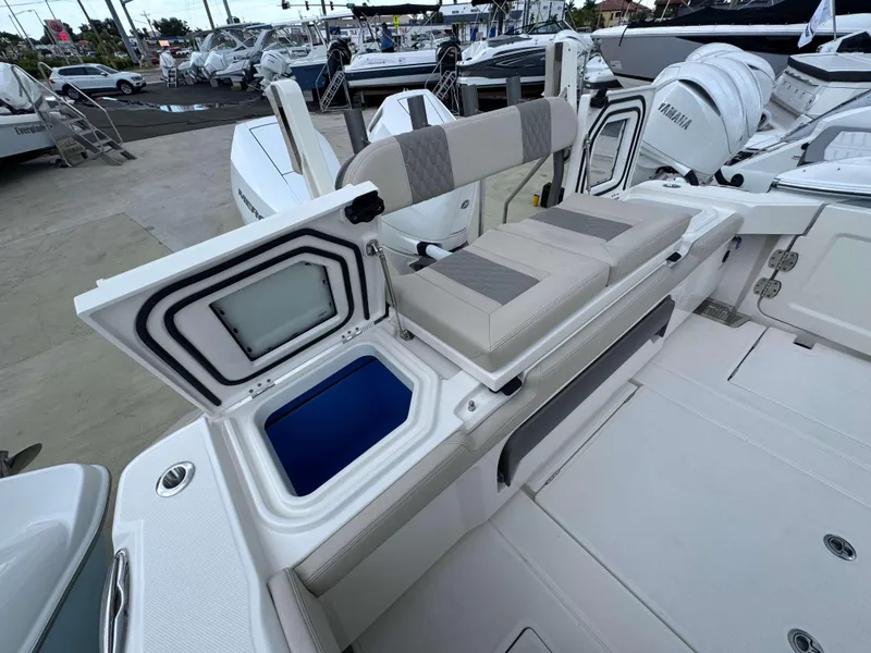 Slide: The Image of 2024 Solace 32 CS boat interior with open storage compartment and cushioned seating. - 26