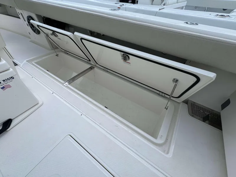 Slide: The Image of 2024 Solace 32 CS boat storage compartments open. - 27