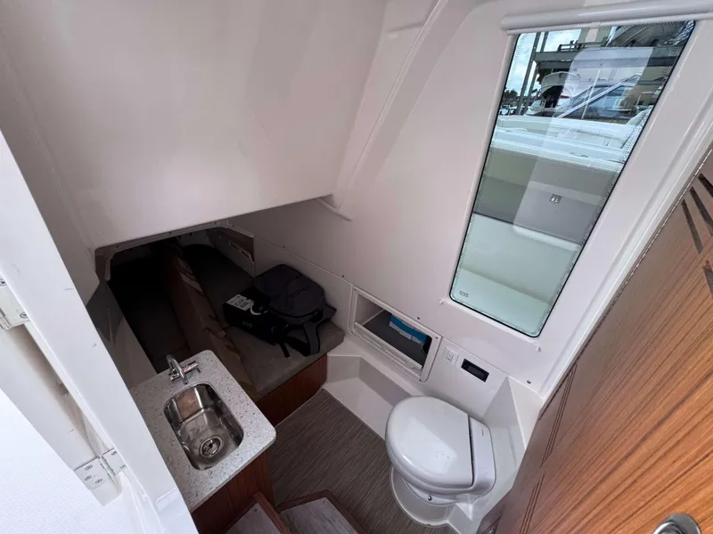 Slide: The Image of Interior cabin of 2024 Solace 32 CS boat with sink and toilet. - 28