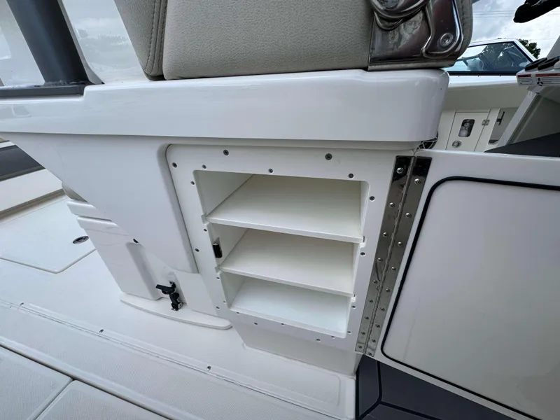 Slide: The Image of 2024 Solace 32 CS boat interior storage compartment with shelves. - 29