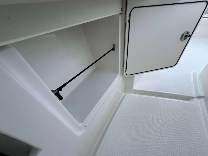 Slide: The Image of Open storage compartment on a 2024 Solace 32 CS boat. - 31