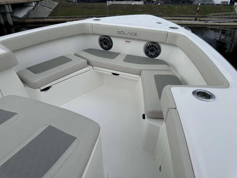 Slide: The Image of 2024 Solace 32 CS boat interior with cushioned seating and cup holders. - 5