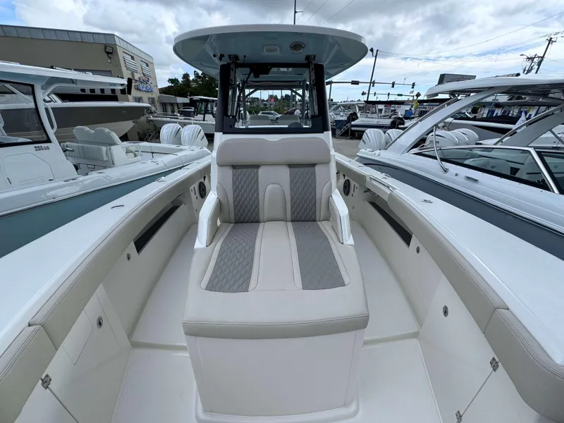 Slide: The Image of 2024 Solace 32 CS boat interior with cushioned seating and modern design. - 8