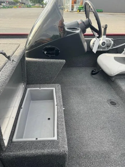 Slide: The Image of 2024 Crestliner 1600 Storm boat interior with storage compartment and steering console. - 10