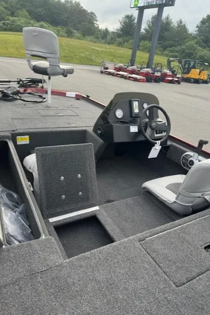 Slide: The Image of 2024 Crestliner 1600 Storm fishing boat interior with seating and steering console. - 11