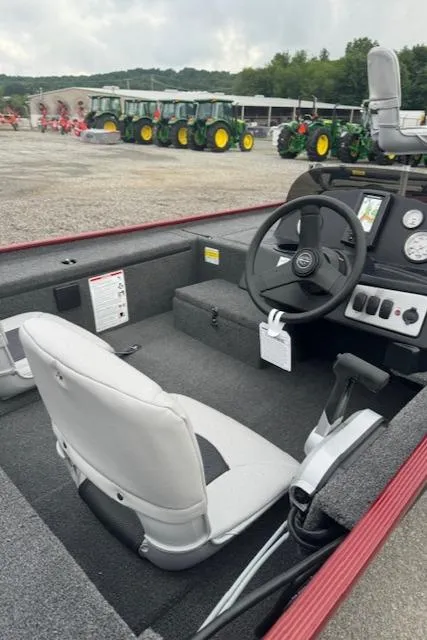 Slide: The Image of 2024 Crestliner 1600 Storm boat interior with steering wheel and seat. - 13