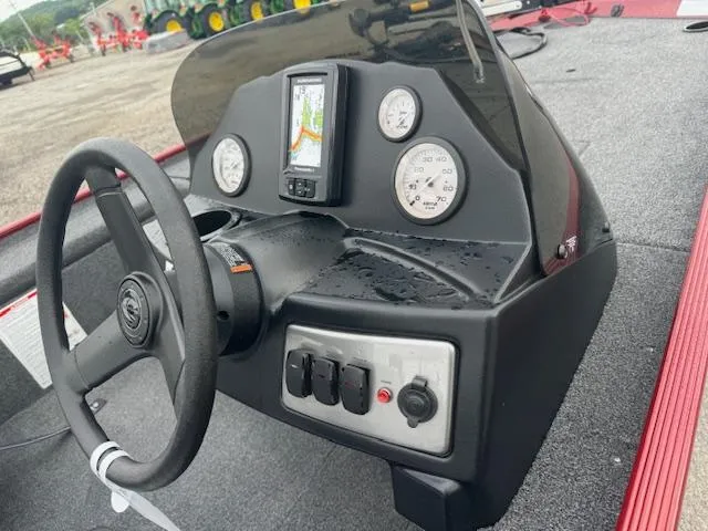 Slide: The Image of 2024 Crestliner 1600 Storm boat dashboard with steering wheel, gauges, and navigation system. - 15