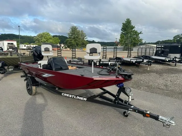 Slide: The Image of 2024 Crestliner 1600 Storm fishing boat on trailer in parking lot. - 2