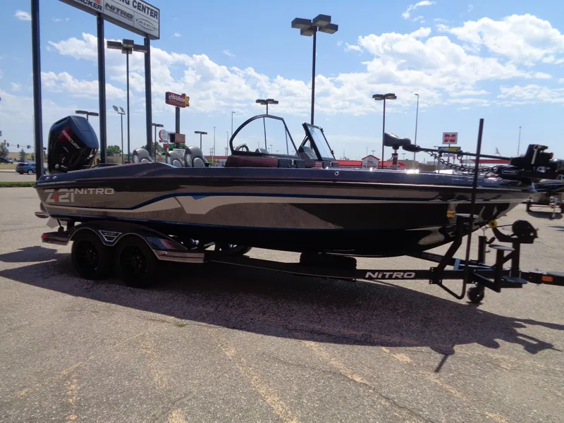 Slide: The Image of 2024 Nitro ZV21 fishing boat on trailer in parking lot. - 4