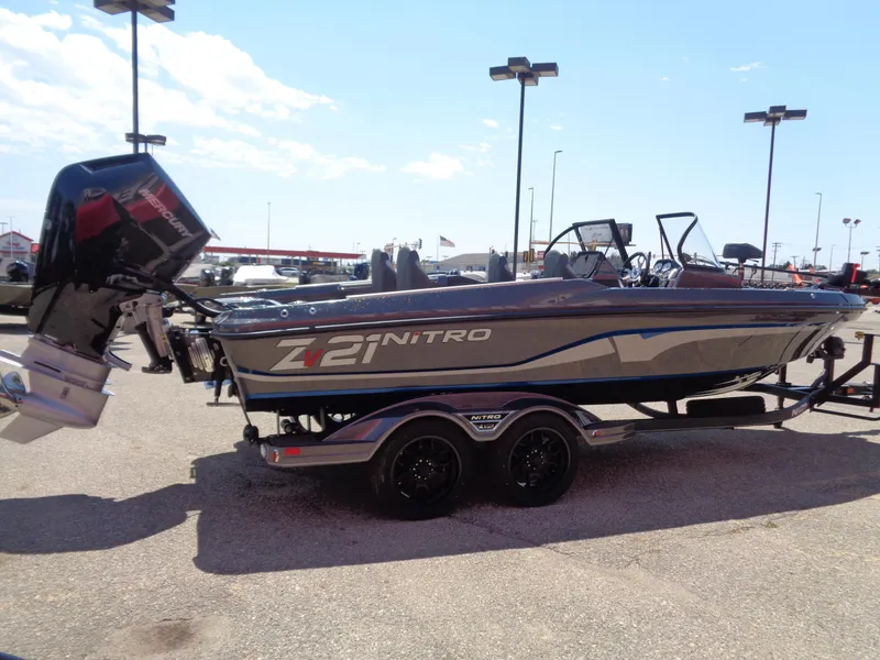 Slide: The Image of 2024 Nitro ZV21 boat on a trailer in a parking lot. - 5