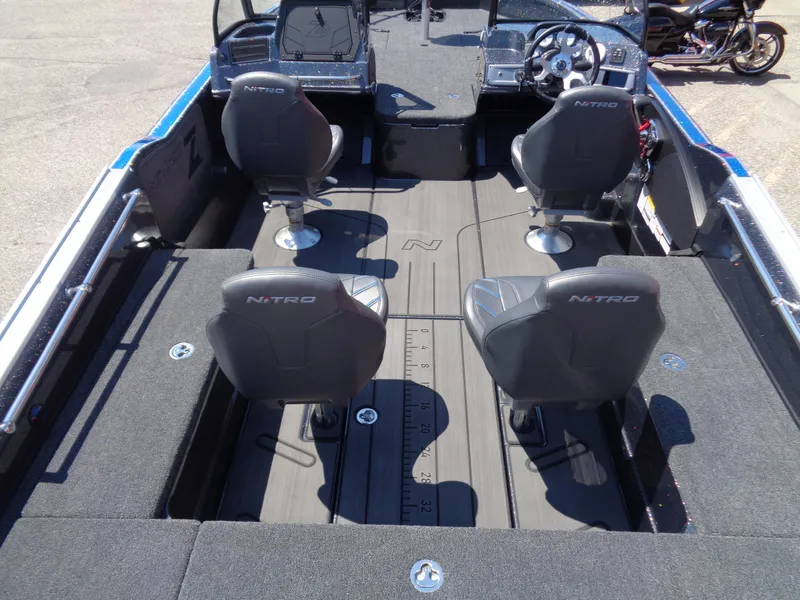 Slide: The Image of 2024 Nitro ZV21 fishing boat interior with four seats and steering console. - 6