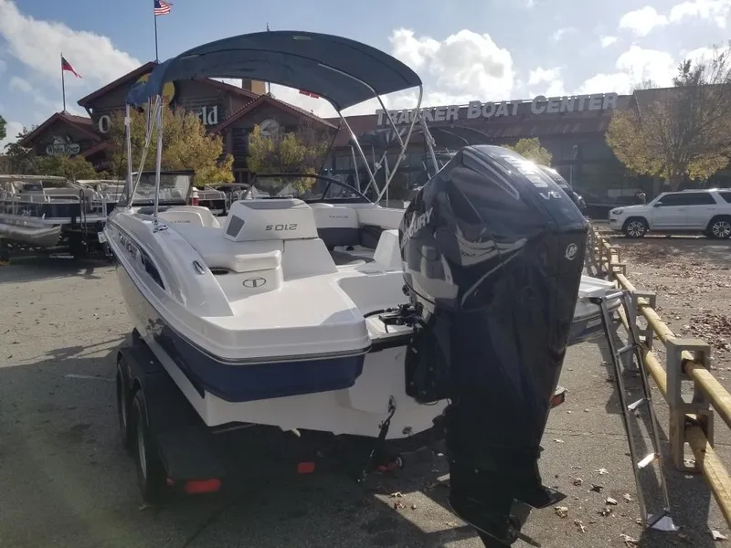 Slide: The Image of 2024 Tahoe 210 S boat with outboard motor at a boat center. - 7