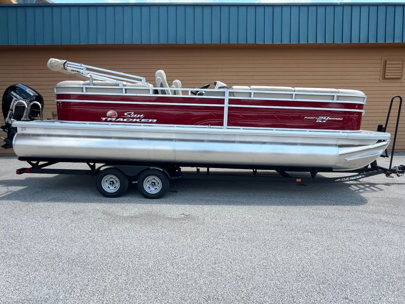 The Image of 2024 Sun Tracker Party Barge 24 DLX pontoon boat on trailer. - 0