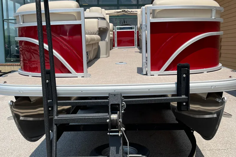 Slide: The Image of 2024 Sun Tracker Party Barge 24 DLX pontoon boat, red exterior, on trailer. - 2