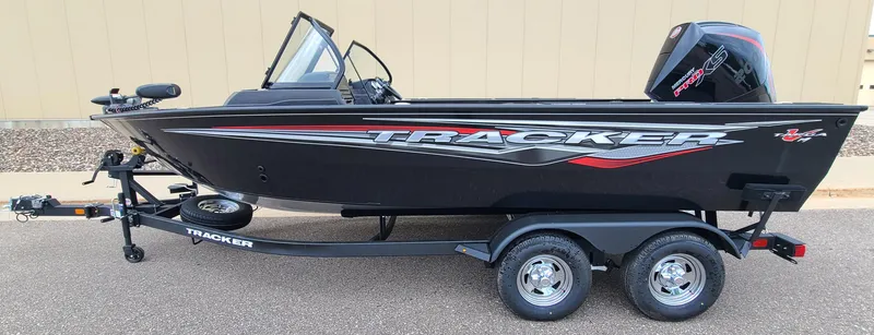 The Image of 2024 Tracker Targa V-19 WT boat on trailer, black with red accents. - 0