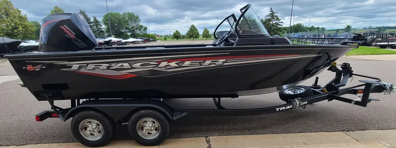 Slide: The Image of 2024 Tracker Targa V-19 WT boat on trailer, parked outdoors. - 3