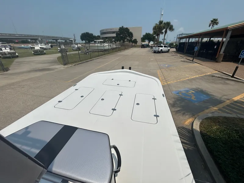 Slide: The Image of 2025 Shallow Stalker 240 RC Elite boat at a marina parking lot. - 11