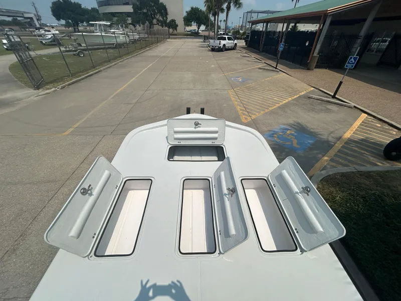 Slide: The Image of Shallow Stalker 240 RC Elite 2025 boat with open storage compartments. - 12