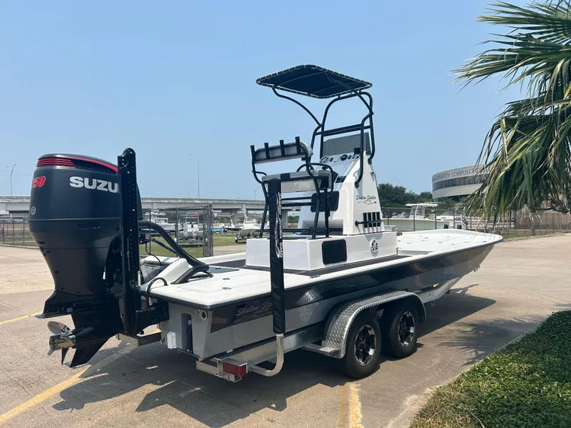 Slide: The Image of 2025 Shallow Stalker 240 RC Elite boat on a trailer with Suzuki outboard motor. - 3