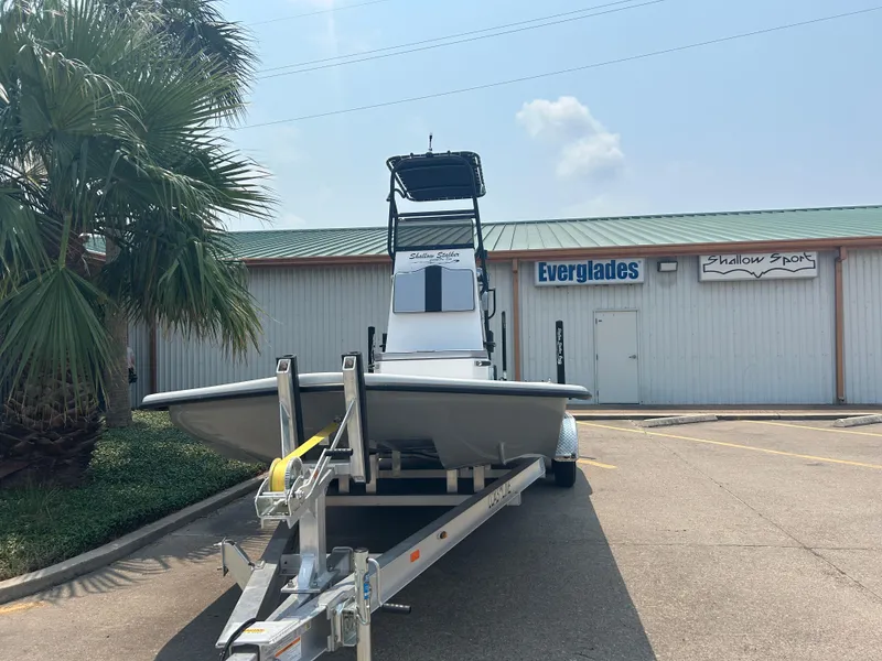 Slide: The Image of 2025 Shallow Stalker 240 RC Elite boat on trailer outside Everglades Shallow Shop. - 4