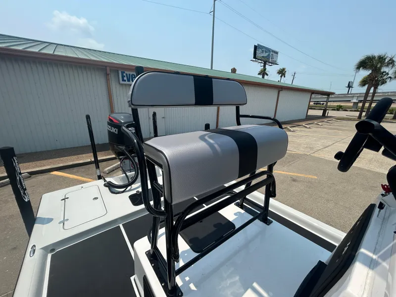 Slide: The Image of 2025 Shallow Stalker 240 RC Elite boat with cushioned seating and Suzuki outboard motor. - 7