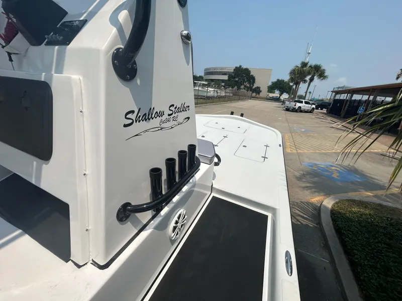 Slide: The Image of Shallow Stalker 240 RC Elite 2025 boat docked at a marina. - 9