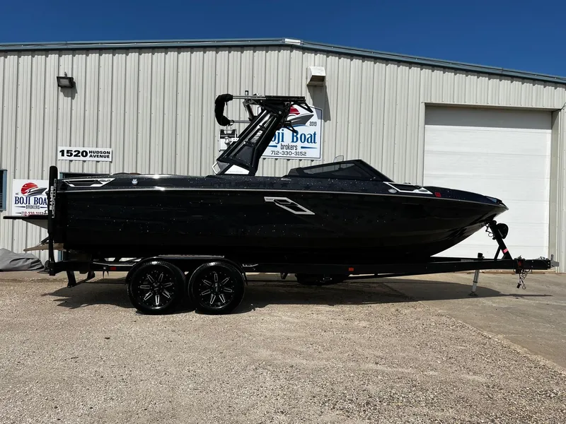Slide: The Image of 2021 Centurion Ri245 boat on trailer outside dealership. - 0