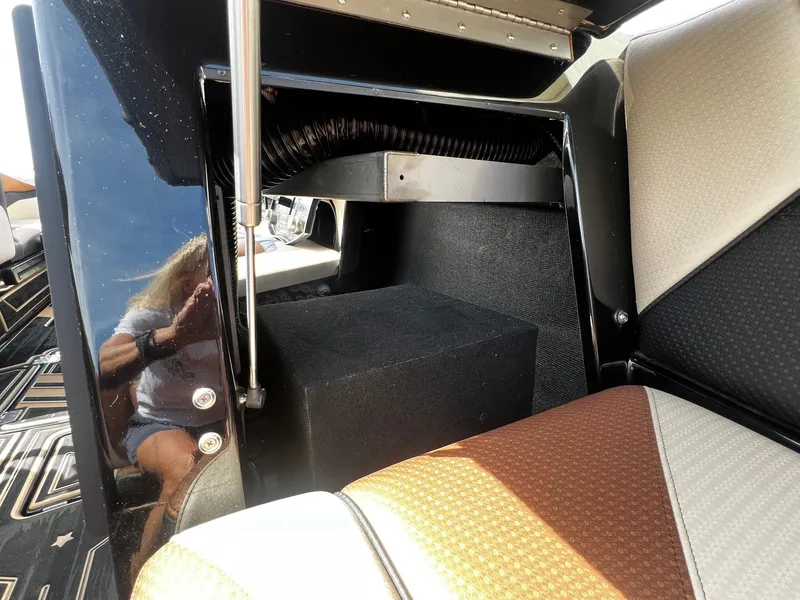 Slide: The Image of Interior of a 2021 Centurion Ri245 boat showing seating and storage area. - 16
