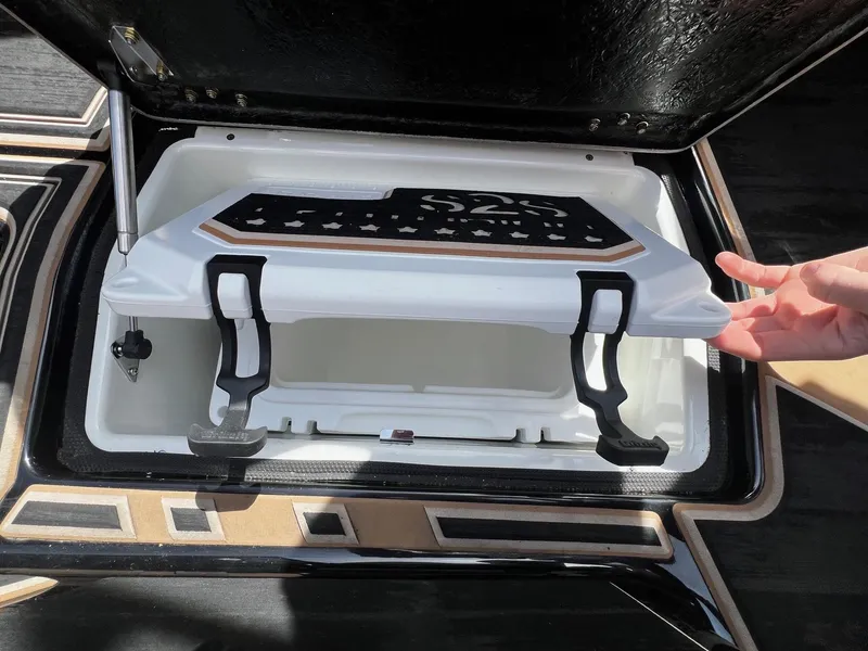 Slide: The Image of 2021 Centurion Ri245 storage compartment with open lid and hand for scale. - 20