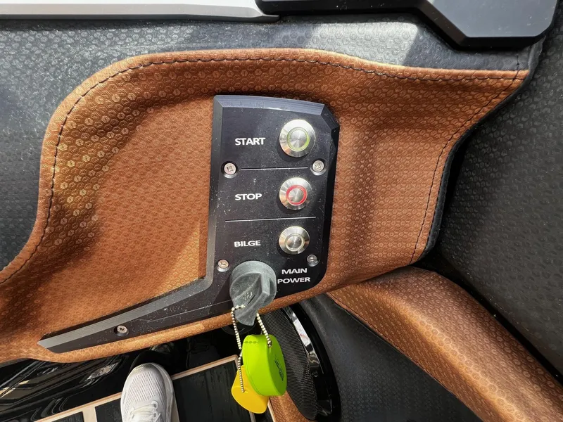 Slide: The Image of Control panel of a 2021 Centurion Ri245 boat with start, stop, and bilge buttons. - 25
