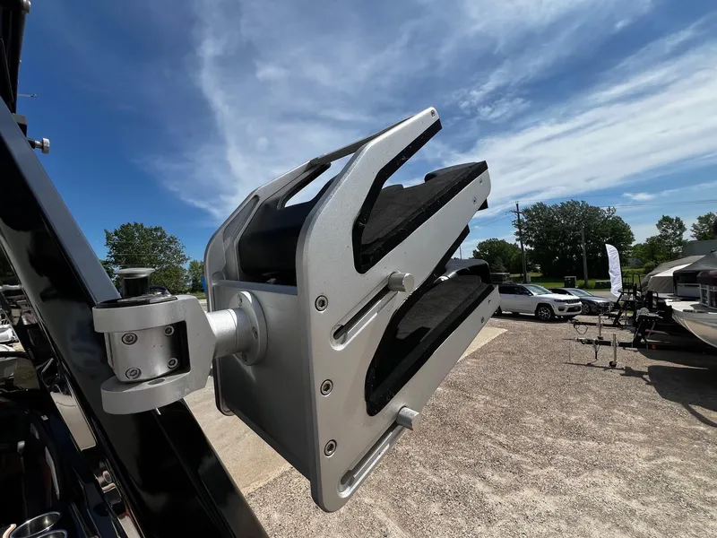 Slide: The Image of Close-up of a 2021 Centurion Ri245 boat's wakeboard rack under a clear sky. - 33