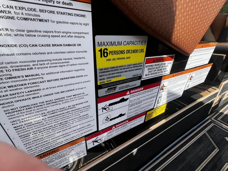 Slide: The Image of Safety and capacity warning labels on a 2021 Centurion Ri245 boat. - 34