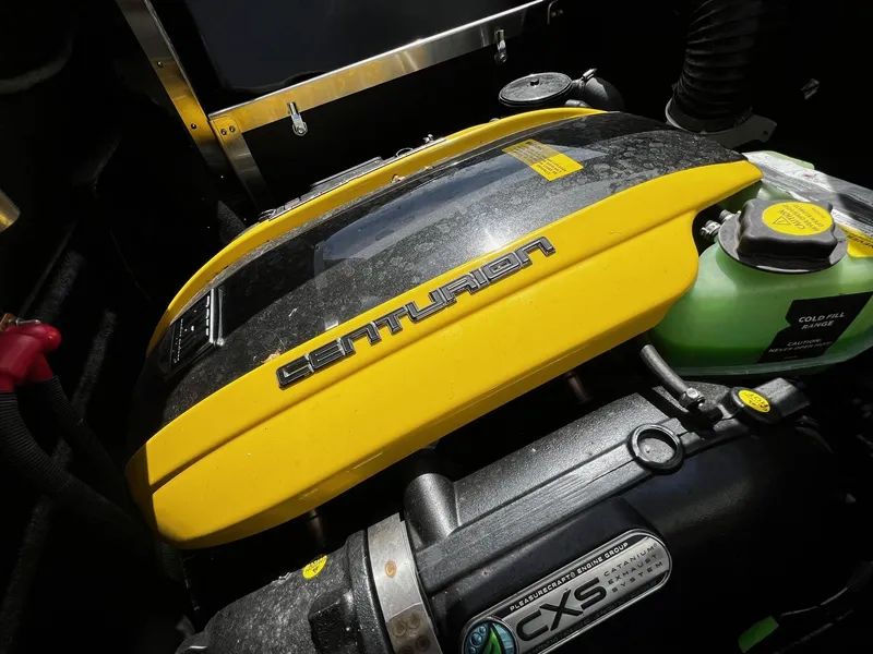 Slide: The Image of Close-up of 2021 Centurion Ri245 engine compartment with yellow cover and coolant reservoir. - 35