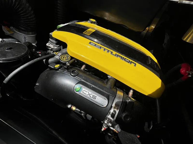 Slide: The Image of Centurion Ri245 2021 engine with yellow cover and CXS branding. - 36