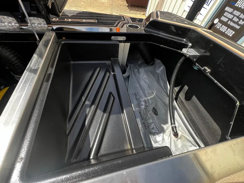 Slide: The Image of Centurion Ri245 2021 boat storage compartment with ballast bag and hoses. - 37