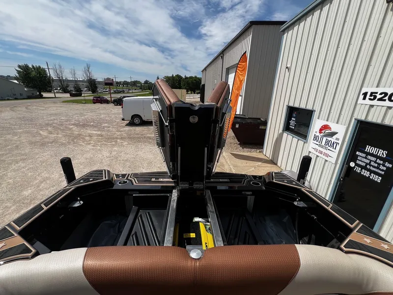 Slide: The Image of 2021 Centurion Ri245 boat at dealership with open engine compartment. - 39