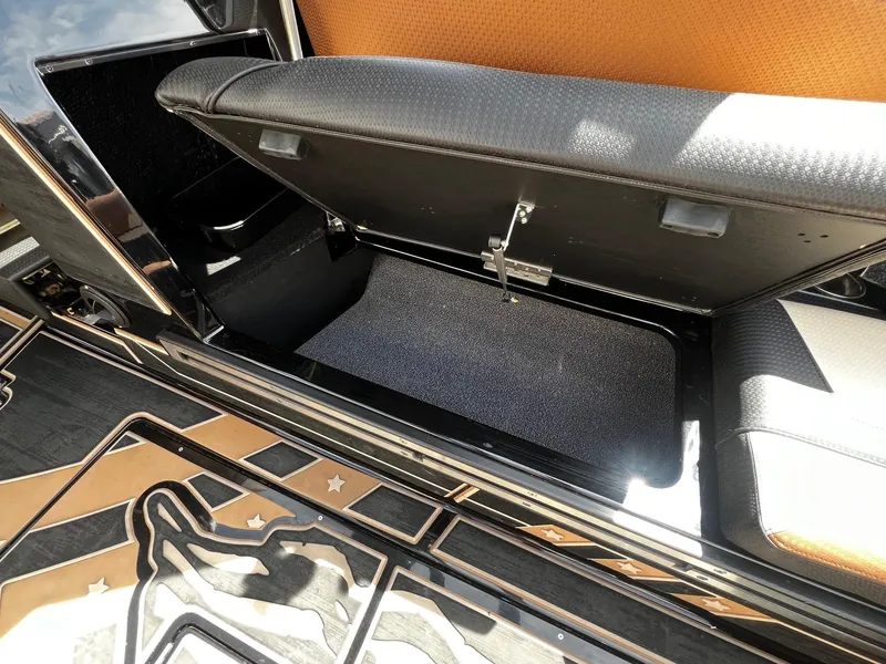 Slide: The Image of 2021 Centurion Ri245 boat storage compartment with open seat and detailed flooring. - 42