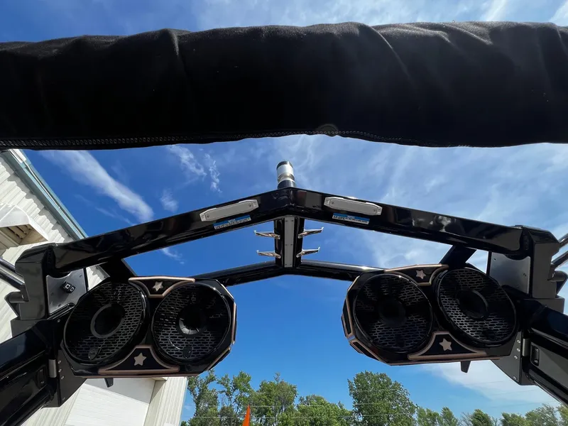 Slide: The Image of Centurion Ri245 2021 boat tower speakers under a clear blue sky. - 44