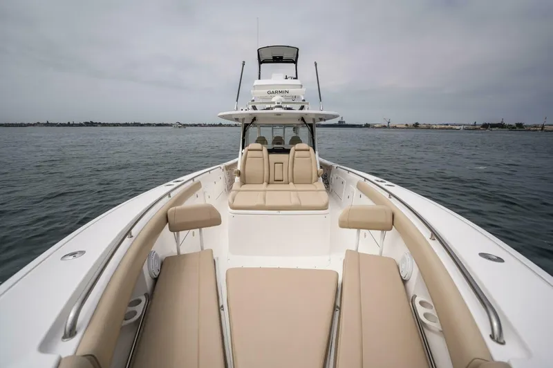 Slide: The Image of 2019 Everglades 435 Center Console boat with spacious seating on calm waters. - 11
