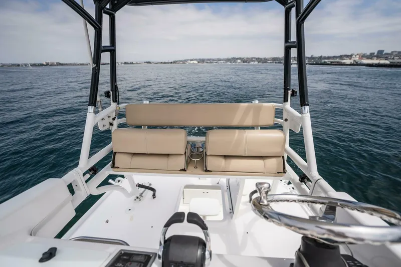 Slide: The Image of 2019 Everglades 435 Center Console boat interior with beige seating and ocean view. - 13