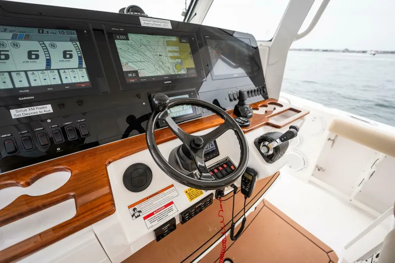 Slide: The Image of 2019 Everglades 435 Center Console helm with advanced navigation and control systems. - 19
