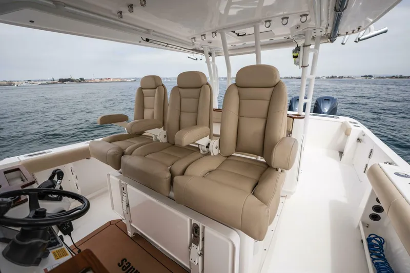 Slide: The Image of 2019 Everglades 435 Center Console boat with beige leather seats on open water. - 21