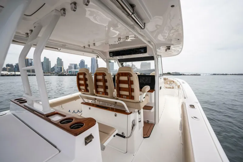 Slide: The Image of 2019 Everglades 435 Center Console boat interior with city skyline in background. - 23