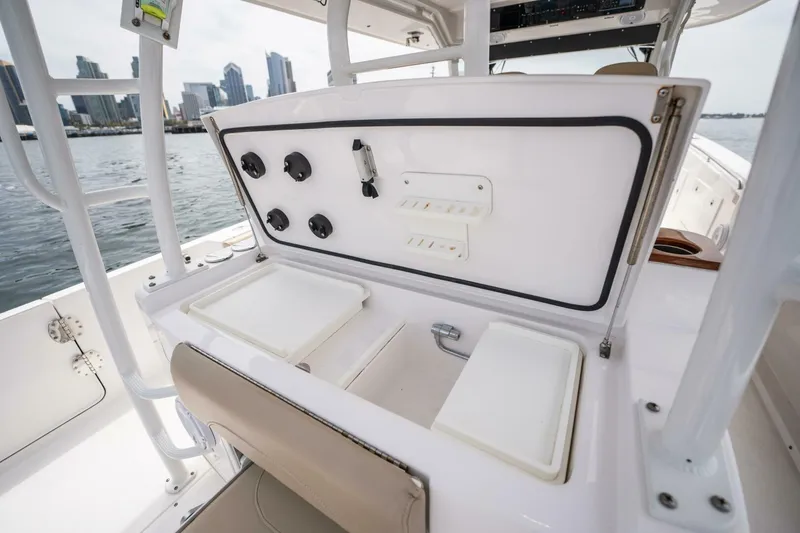 Slide: The Image of 2019 Everglades 435 Center Console boat with open storage compartments and city skyline in background. - 26